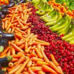 Vibrant selection of fresh fruits and vegetables on a market stall. Healthy eating and organic living.
